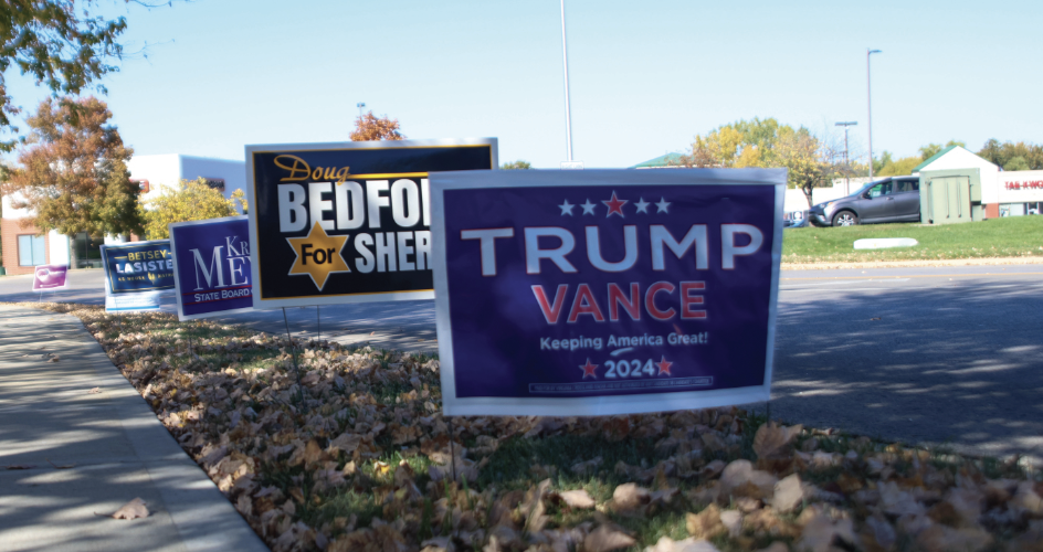 Election signs found lined up outside near the Johnson County Public Library Monday, Oct. 21.